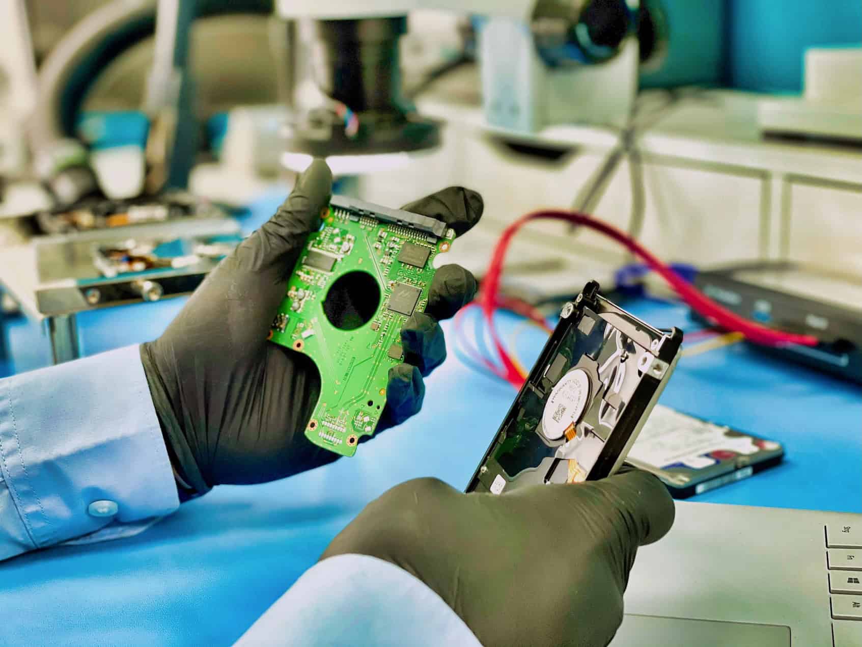Technician evaluating a hard drive electronics board in the Fixfactor recovery lab