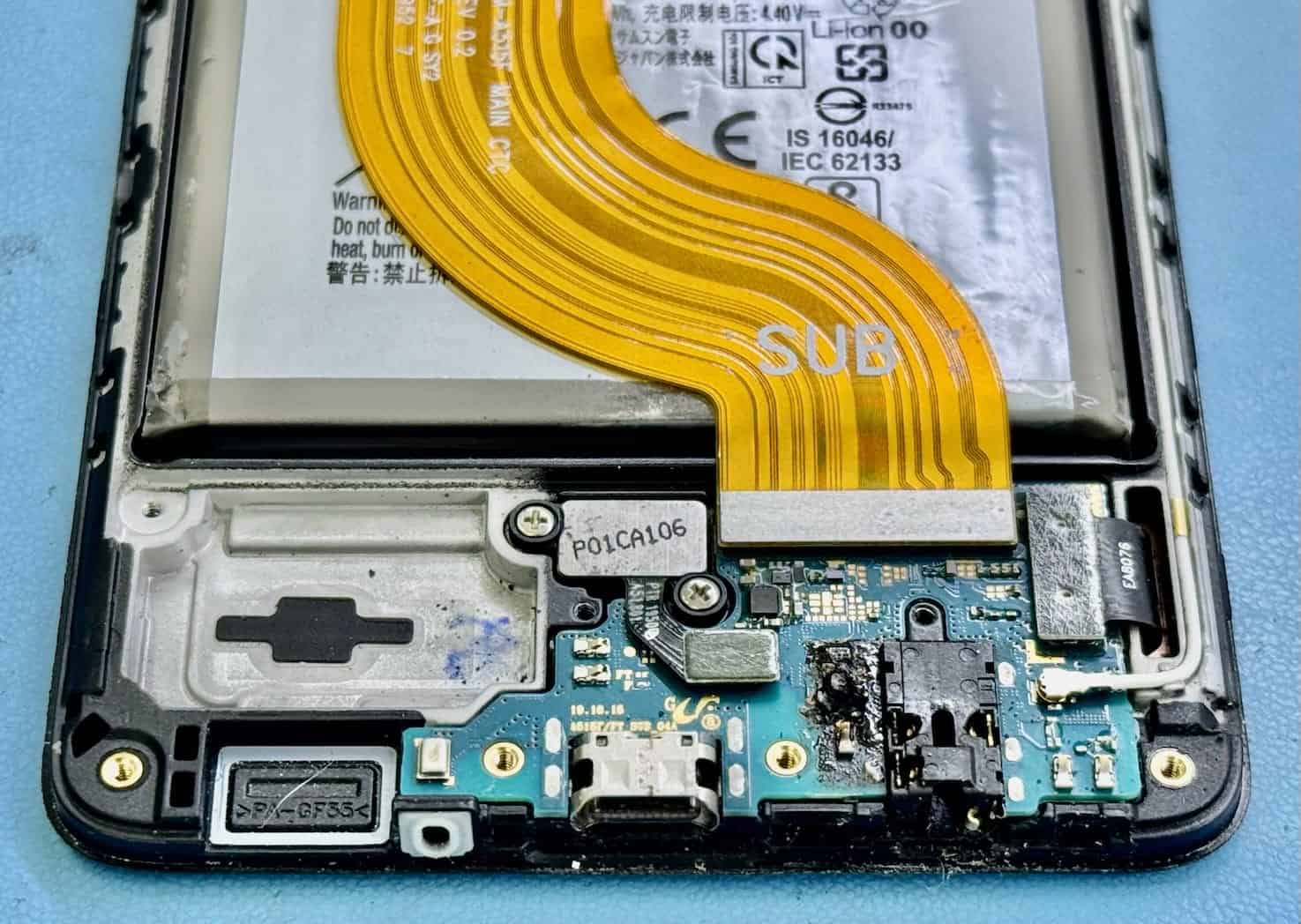 Close look at corrosion on a liquid-damaged motherboard